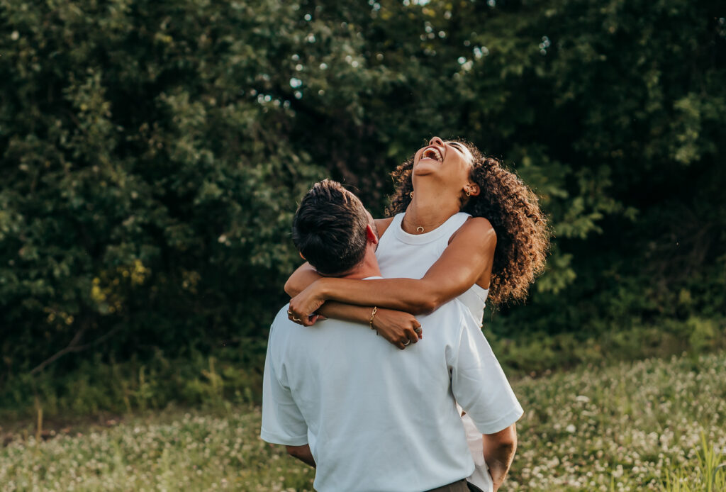Paar lacht ausgelassen bei einem romantischen Fotoshooting in der Natur im Saarland